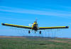 An airplane spraying crops with fertilizer or pesticide